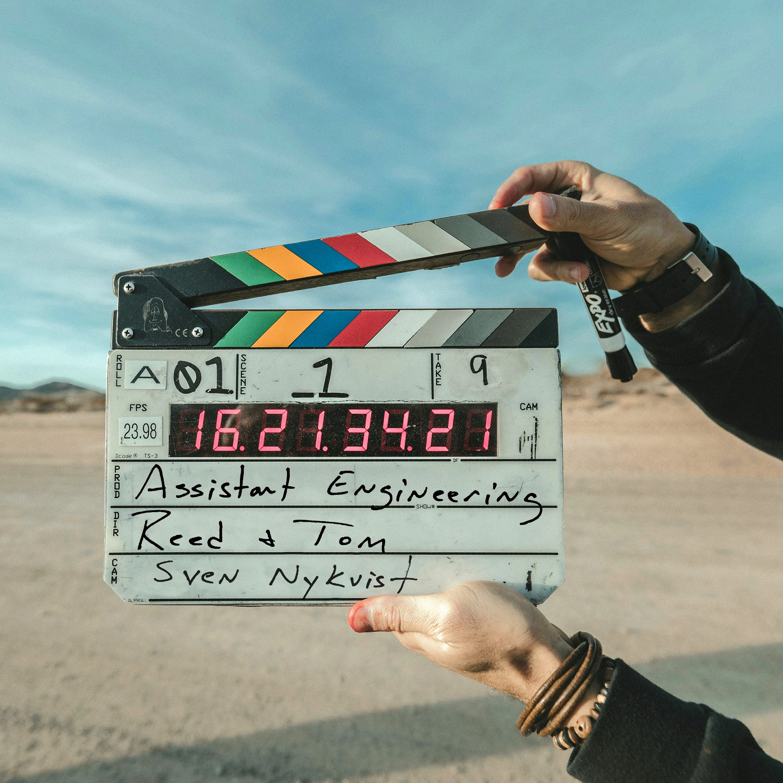 Two hands on a film clapper that starts a shot.