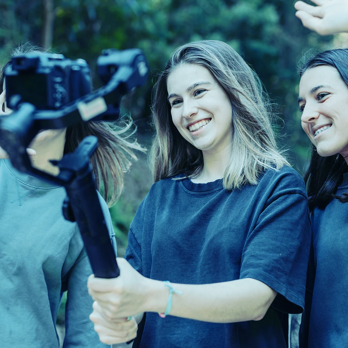 A group of women smiling in front of a professional camera rig.